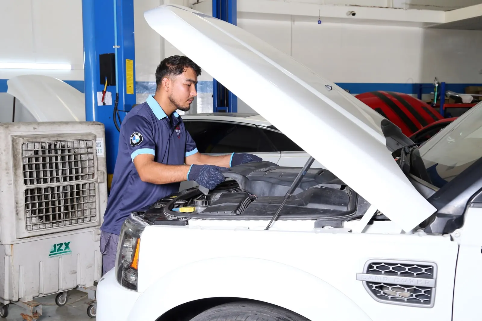 Diagnostic technician working on a vehicle inside the Missak workshop