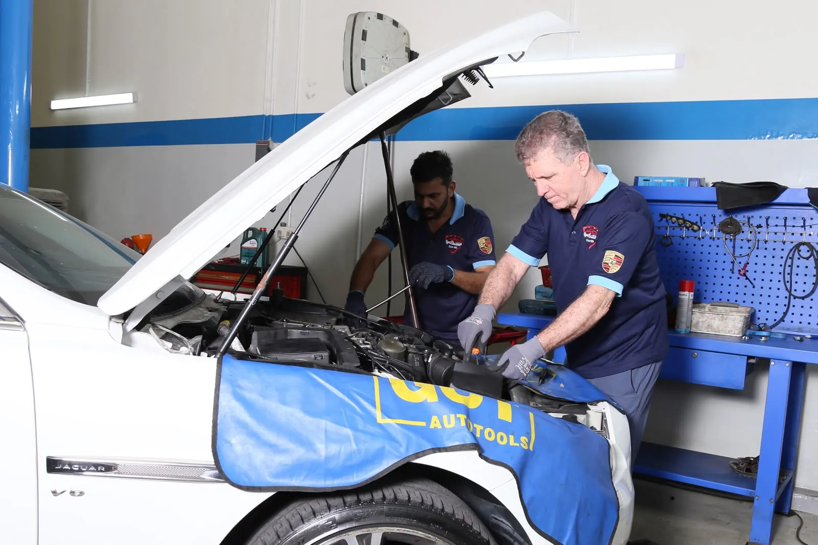 Missak technicians diagnosing an engine in the Mussafah workshop